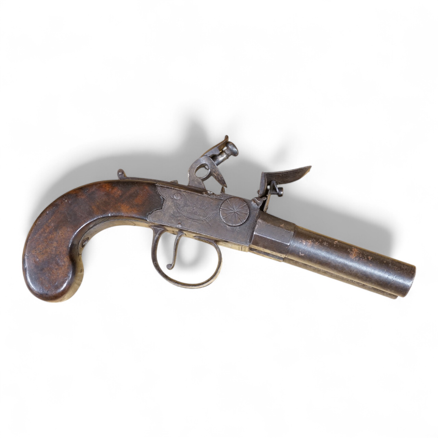 A double barrel flintlock, tap action pocket pistol by Collis of Oxford, with sliding top thumb safety, slab walnut grip, and tower private proof marks